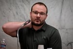 Charles Button, 24, testifies during the third day in the trial of Jeremy Christian at the Multnomah County Courthouse in Portland, Ore., Jan. 30, 2020. Button attempted to administer aid to one of the victims the day of the attack.