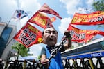 A protester wears a mask of former South Korean President Yoon Suk Yeol during a rally in support of a hearing to review a special prosecutor's request for his arrest, near the Seoul Central District Court in Seoul, South Korea, on Wednesday, July 9, 2025. The writing reads "Yoon Suk Yeol sentenced to death."