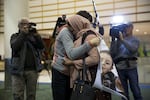 Mustafa Abed's mother, Nidhal Aswad, hugs pediatric social worker Geri Berg. She helped him last time he was in Portland, 10 years ago.