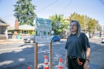 Aaron Gilman stands by one of the misting stations that were installed at Portland outdoor parks on Aug. 14, 2023. The stations spouted misted water over the sidewalk and provided cold drinking water.