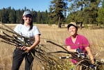 Stasie Maxwell, Indigenous Partnerships Program Manager, and Education Director Jeanine Moy with a fresh harvest of willow stakes.