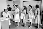 At the central office of the Salvadoran Human Rights Commission, a staff member, left, listens to women relay their cases regarding disappeared family members in San Salvador, El Salvador, August 1983. (Photo by Robert Nickelsberg/Getty Images)