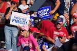 Members of the crowd react as U.S. Secret Service agents surround Republican presidential candidate former President Donald Trump at a campaign event in Butler, Pa., on Saturday, July 13, 2024.