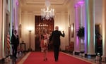 President Biden and first lady Jill Biden walk through the Cross Hall of the White House lit with rainbow colors following an event commemorating LGBTQ+ Pride Month in the East Room last year.