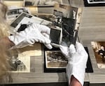 Cynthia Basye looks at an archived photo of Daiichi Takeoka at the library of Japanese American Museum of Oregon in Portland. Takeoka, a first-gen Japanese American community leader, graduated from the University of Oregon’s law school in 1912 but wasn't allowed to practice because he didn’t have U.S. citizenship. 