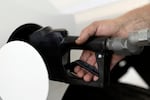 A man pumps his own gas Friday, Aug. 4, 2023, in Eugene, Ore. Holiday gas prices in Oregon are the lowest they've been since 2020.