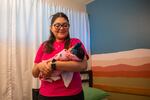 A certified nursing assistant comforts an infant who recently arrived at Jacob’s Hope, a specialty nursery in Mesa, Arizona, that helps care for substance-exposed newborns and their parents.