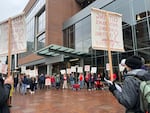 Portland State University faculty and staff protest against looming workforce cuts outside a board of trustees meeting on Jan. 30, 2026.