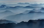 Craggy mountain peaks are blanketed in wildfire smoke in the Northern Cascade range near Mazama, Wash., in September.