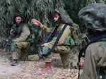 Israeli soldiers take up position in Kfar Aza, in the south of Israel, bordering Gaza Strip on Tuesday, Oct. 10, 2023.