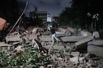 A man jumps on a collapsed building after an earthquake in Caracas, Venezuela.