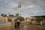 Mohammad Abu Queider and his wife Mayada walk through al-Zarnuq.