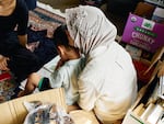 A mother and her young son sit in the playroom of a house that offers temporary shelter for migrants in Queens, N.Y. They both crossed into the U.S. without authorization in the past year.