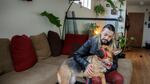 Leonardo Cruz and his emotional support dog, Aurora, at their home in Portland, Friday, Jan. 22, 2021.