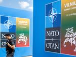 A security guard walks in front of the venue in Vilnius, Lithuania where the NATO summit will be held this week.