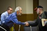 State Sen. Floyd Prozanski, D-South Lane and North Douglas counties, greets a member of the public at the conclusion of the Oregon Senate Judiciary Committee's hearing on Senate Bill 978 the Oregon Capitol in Salem, Ore., Tuesday, April 2, 2019. An opponent of the gun control bill shares his thoughts with the head of the committee after it adjourns.