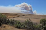 Smoke from the Substation Fire rises over the hills near Moro, Oregon, Wednesday, July 18, 2018.