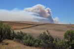 Smoke from the Substation Fire rises over the hills near Moro, Oregon, Wednesday, July 18, 2018.