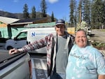 Contractor Steve Severin, left, and local business owner Melanie Stanley, right, pause outside an area of Blue River that's getting rebuilt after a devastating wildfire.