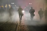 Police deploy tear gas during demonstrations in downtown Portland, Ore., Saturday, May 30, 2020. The death of George Floyd at the hands of a white Minneapolis police officer sparked nationwide protests against police brutality amid the COVID-19 pandemic.