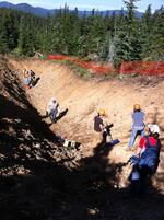 Scientists begin cleaning debris from a 15-foot deep trench on Blue Ridge near Mount Hood. They hope exposed geologic layers will reveal clues about the how big and how often earthquakes happen on a fault line found here.
