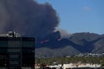 Plumes of smoke are seen as a brush fire burns