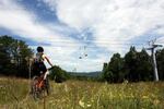A mountain biker beneath a chairlift at Vermont's Mount Snow Resort. A proposal to add 17 miles of mountain bike trail on Oregon's Mount Hood is opposed by environmentalists.