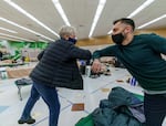 Gubernatorial candidate Tina Kotek, left, bumps elbows with Do Good Multnomah Deputy Director Daniel Hovanas, as Kotek tours the homeless shelter Arbor Lodge in North Portland, Jan. 20, 2022. 