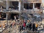 The civilian death toll in Gaza has led to growing calls for Israel to shift tactics in its assault on the Palestinian territory. Above, people survey the damage from an airstrike in Tel al-Sultan in Rafah.