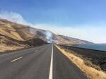 A fire burns along the Columbia River south of Highway 14 in Washington state Wednesday afternoon.
