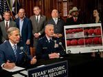 Texas Gov. Greg Abbott (left) speaks about a new border security measure during a news conference at the Texas State Capitol on June 8.