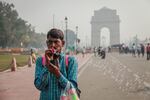 Gajender Kohli blows bubbles to attract customers near India Gate in New Delhi. He says the air pollution hurts business. "It makes me sick. It makes the kids sick."