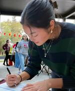 Pacific University student Caitlyn Sato fills out a voter registration form at a Pacific Votes event on Oct. 11, 2024.