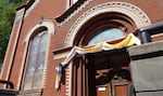 The outside of St. Michael the Archangel Catholic Parish in Portland, Ore., on May 8, 2025. The yellow and white bunting signifies the election of a new pope.