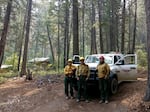 Firefighters with Methow River Wildfire worked to protect buildings during the Crescent Mountain Fire. Engine boss Steven Baltrusch (right) also works various jobs during the off season. Also pictured: Allen Dolph and Richie Harvey.