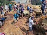 Villagers search through a landslide in Yambali, in the Highlands of Papua New Guinea, on Sunday, May 26, 2024. The International Organization for Migration feared Sunday the death toll from a massive landslide is much worse than what authorities initially estimated.