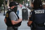 A DEA agent talks with a Metropolitan Police Department officer while patrolling near the Washington Monument.