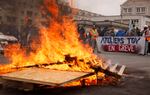 Striking railway workers demonstrate near burning palettes at the Gare de Lyon train station on Tuesday in Paris.