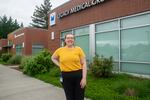 Andrea Crane stands in front of her workplace. Crane is walking in Western Oregon University's commencement ceremony this weekend.