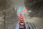 Drivers creep along NW Naito Parkway near Burnside Bridge in Portland, Feb. 22, 2023. Commutes throughout the Portland area were hampered by heavy snowfall, Feb. 22, 2023. 