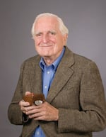 In this image from 2006, Douglas Engelbart poses with his original computer mouse design.