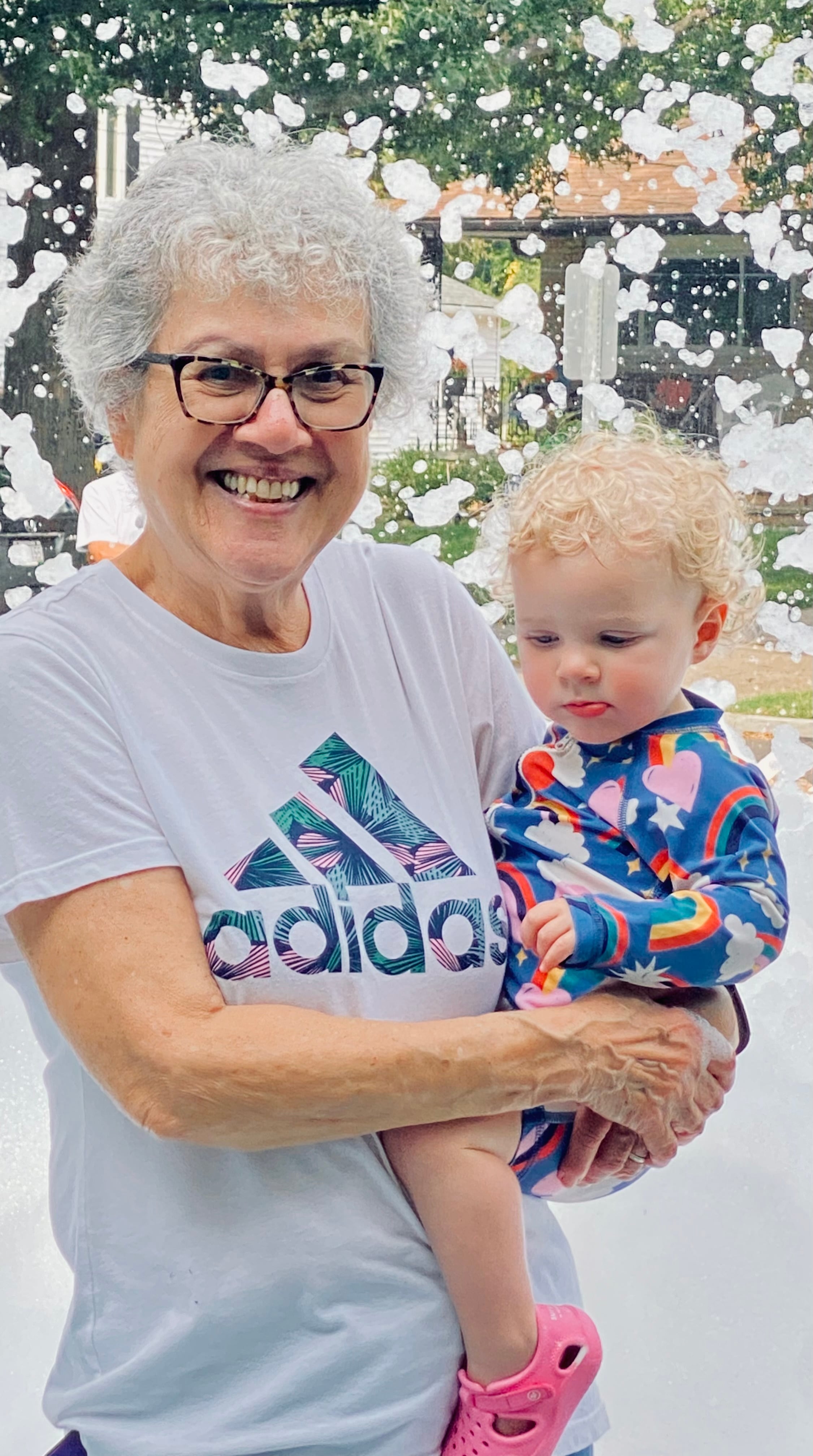 Michael Sweet's mother, Donna Sweet, holds her 18-month-old great-granddaughter, Margot Higgins, during a family event celebrating her wedding anniversary.