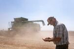 A farmer checks for carrot seeds in his hands on dry day in Central Oregon.