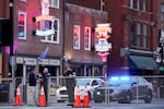 Police block off a part of the Broadway tourist district Monday, Dec. 28, 2020, as a result of a bombing that took place on Christmas Day in Nashville, Tenn. The explosion sparked shock across the country, killed the bomber, injured three other people and damaged dozens of buildings. Yet for those who call Music City home, the bombing feels like a cruel capstone to an already dark year.