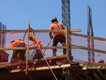 Construction workers work on a construction site in Brooklyn, N.Y., on July 22.