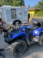 An officer with the Portland Police Bureau holds Bowser the tortoise next to an PPB ATV.