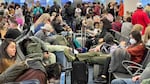 Dr. Anthony Fauci, chief medical adviser to President Biden, cites the U.S. vaccination program and previous widespread transmission of COVID-19 as reasons why the country is not now under pandemic conditions. Here, travelers are seen at Miami International Airport last week, after mask requirements were lifted.