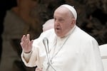 Pope Francis delivers his blessing as he exchanges season greetings with Vatican employees, in the Paul VI Hall at the Vatican, Saturday, Dec. 21, 2024. 