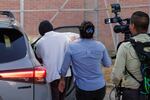 Immigration and Customs Enforcement officer Christian Castro gets into a car surrounded by news reporters moments after being released from the Carrizalez-Rucker Cameron County Detention Center in Brownsville, Texas on Aug. 27, 2026.