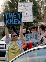 Students protest outside St. Helens High School with signs on Nov. 15, 2024. Many said they felt betrayed by school officials.